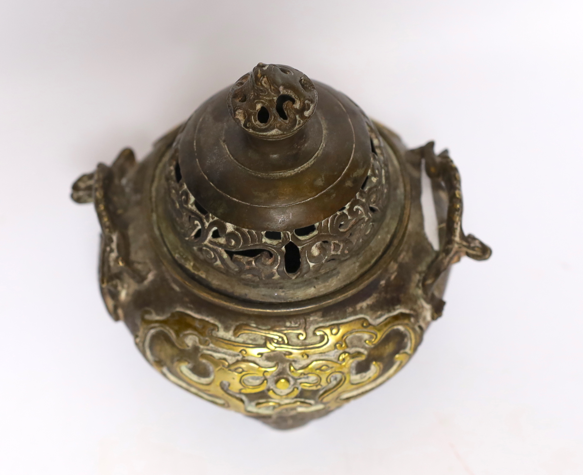 A Chinese parcel gilt bronze censer, with pierced lid and twin zoomorphic handles, 15cm high